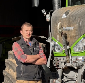 Richard Maddever standing on front of a tractor